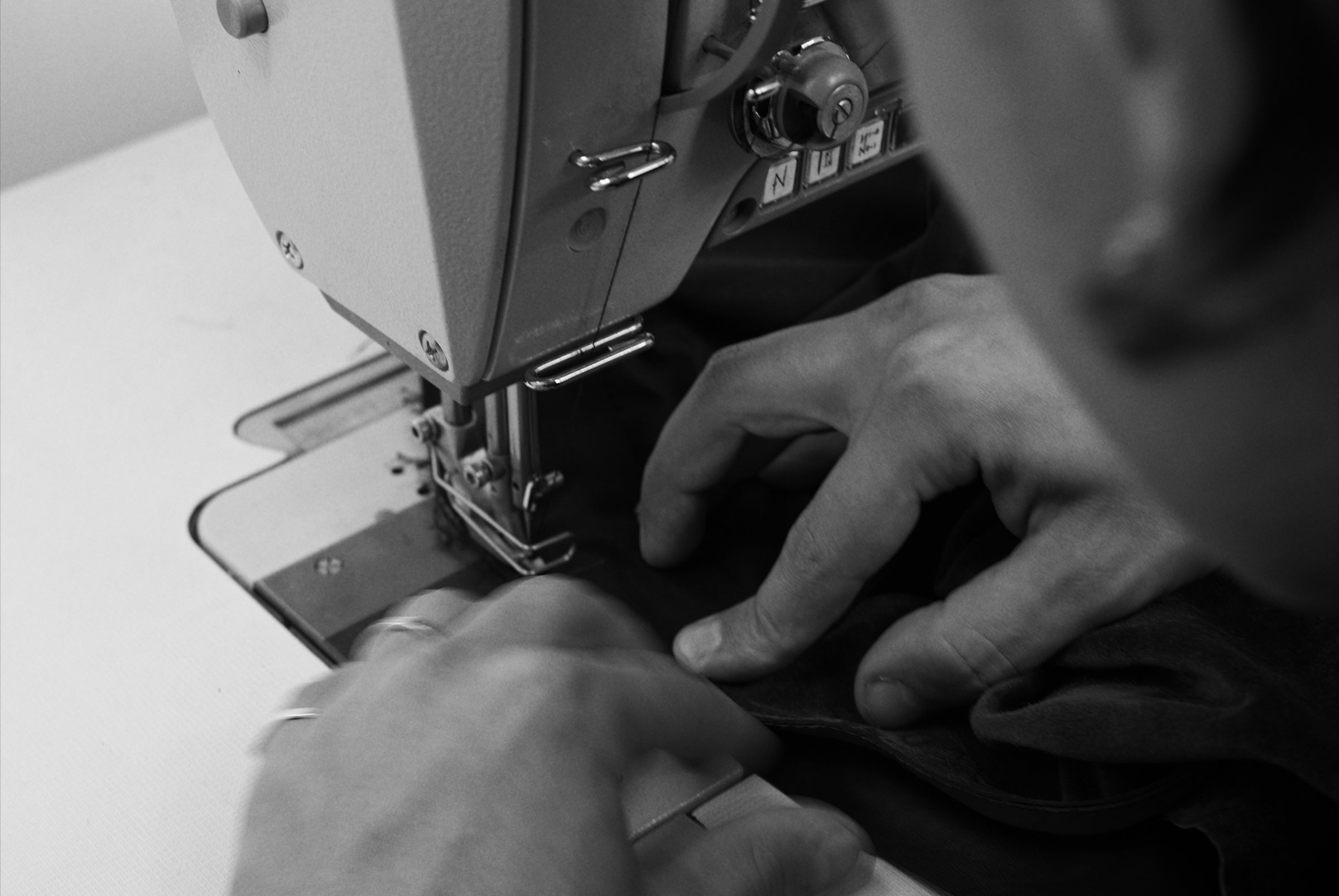 Hand-finishing a garment at the Haderlump atelier, Berlin